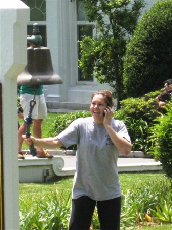 Elise Houston ringing the bell after passing Coast Guard Licensing Exam